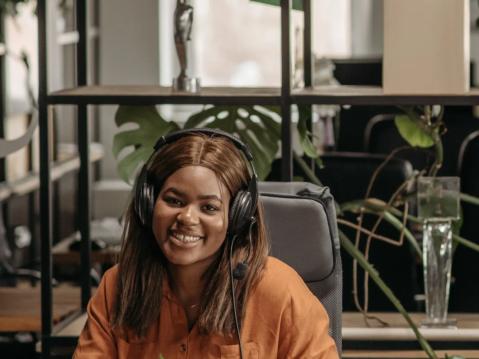 Employee with a headset smiling in an office